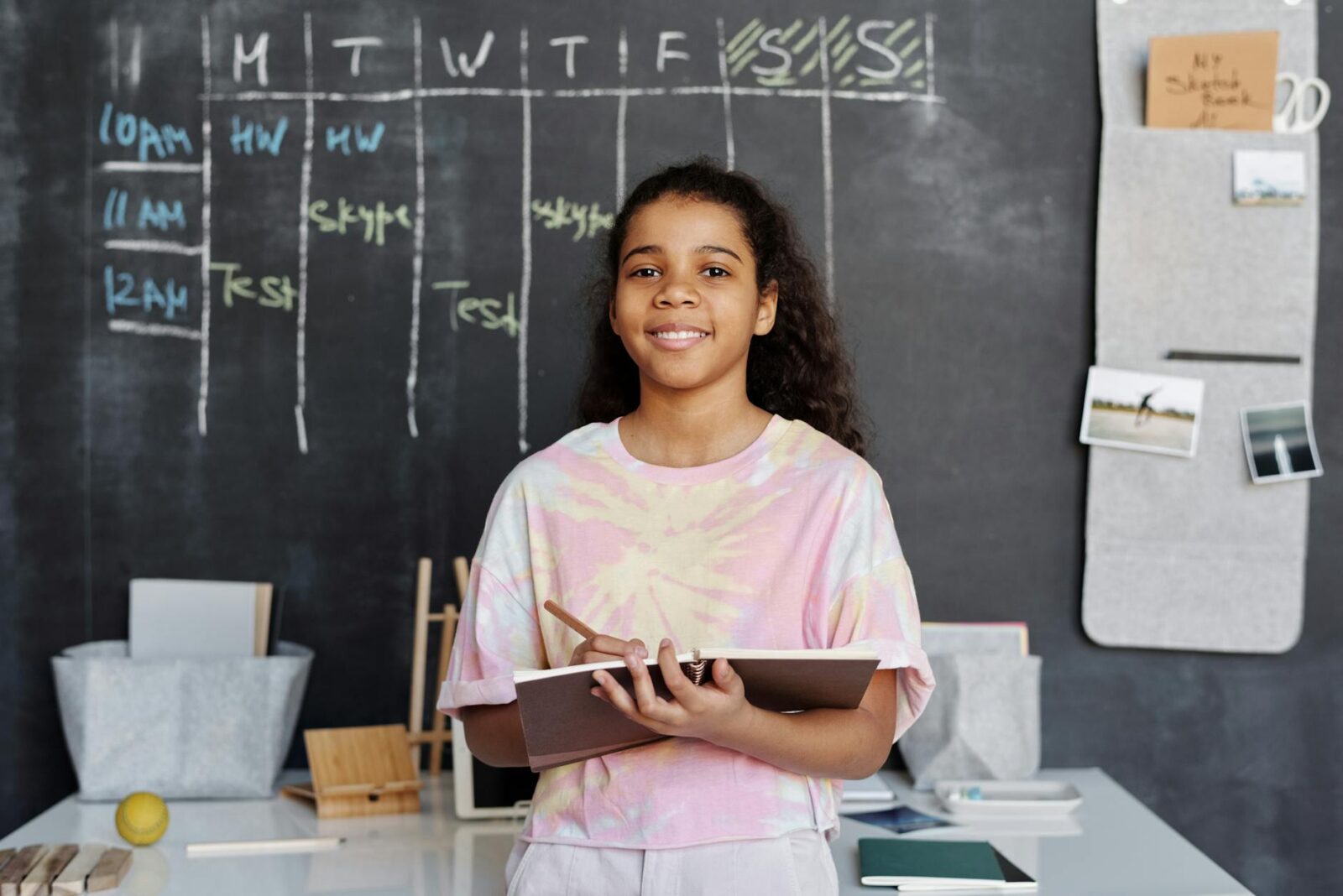 girl in pink shirt holding notebook 12 Essential Life Skills to Teach Your Kids (Beyond School Lessons)
