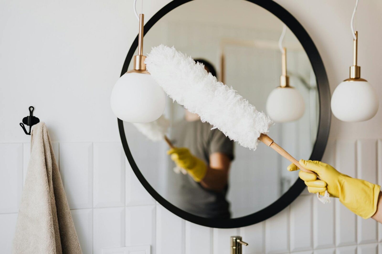 crop woman dusting lamp during housework Selling a House Fast Doesn’t Have to Be Stressful