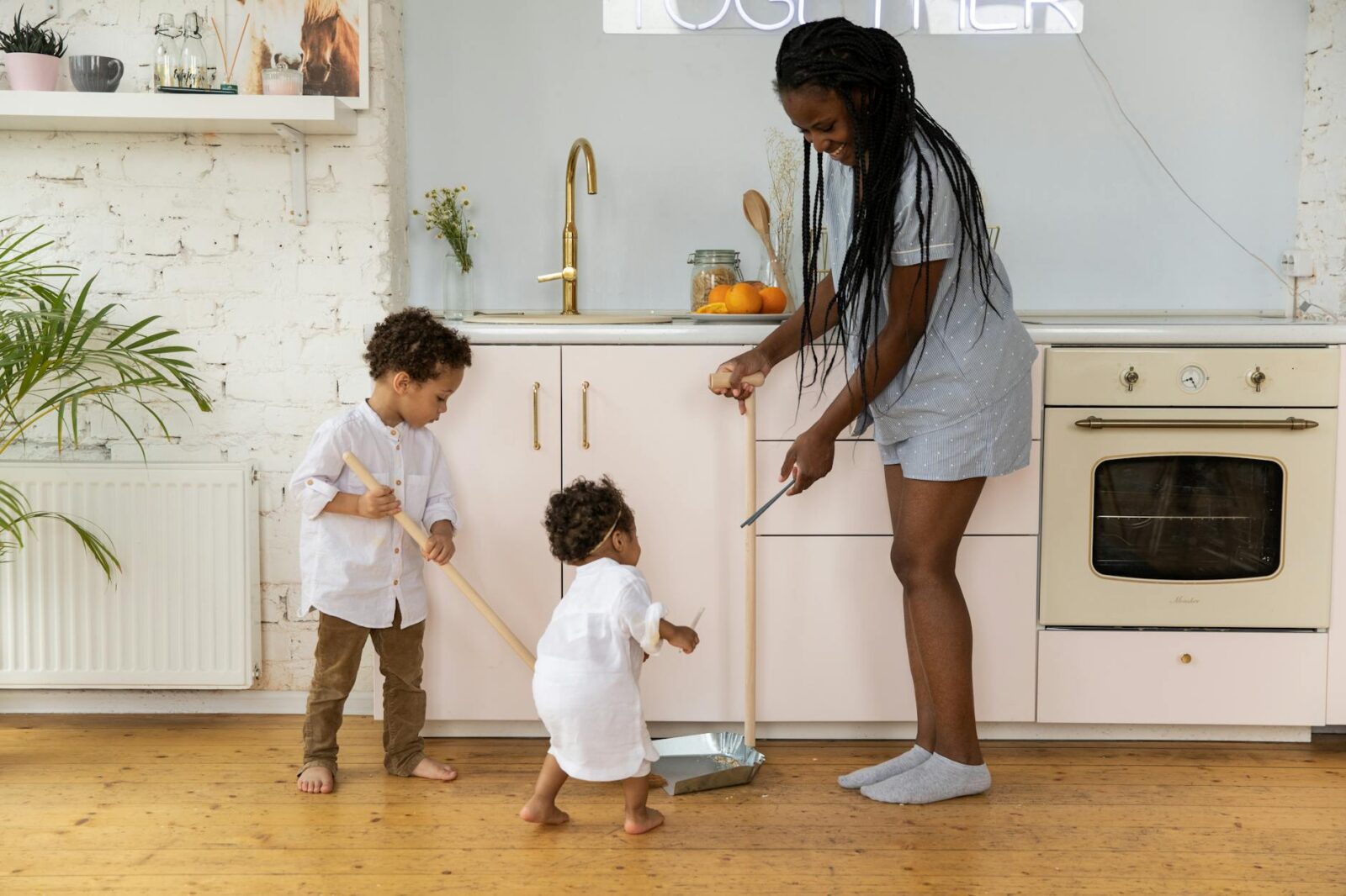 mother and children in kitchen 12 Essential Life Skills to Teach Your Kids (Beyond School Lessons)