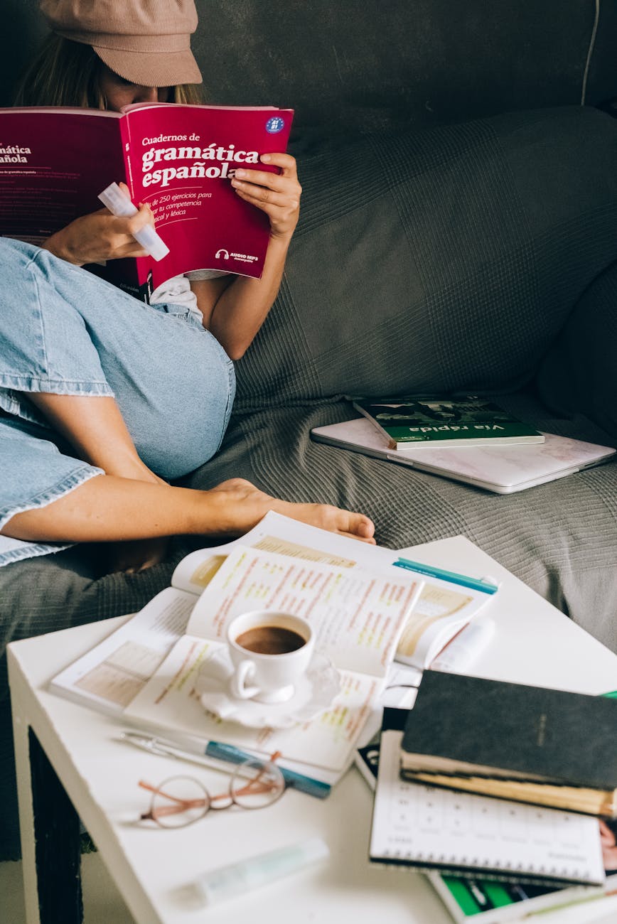 a woman sitting on the couch while reading a book Sabbatical Planning Tips: How to Relax, Travel, and Find New Purpose