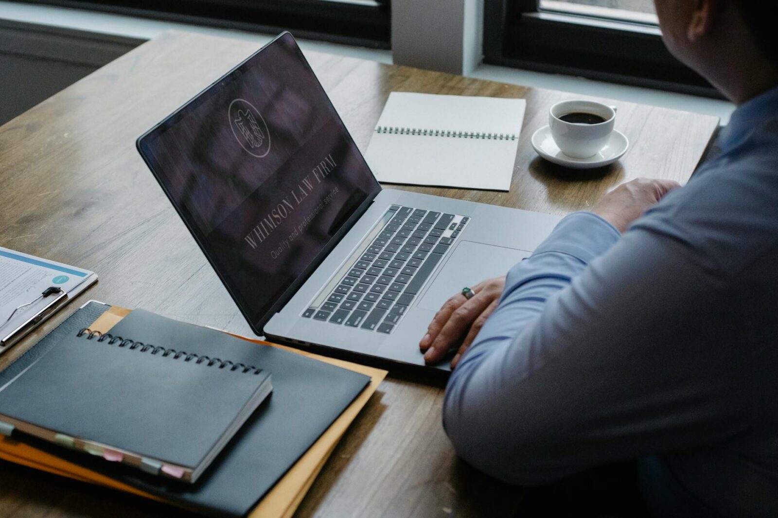 male entrepreneur working at laptop in workplace Law Firm Brand Identity: Positioning Your Practice to Attract Ideal Clients