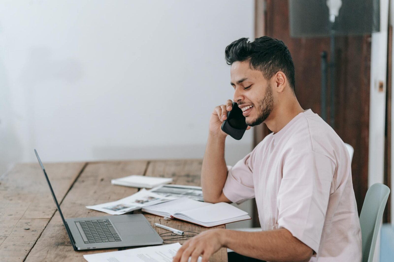 happy businessman speaking on phone at workplace Cash Offers Explained: Are iBuyers and Investors Right for You?