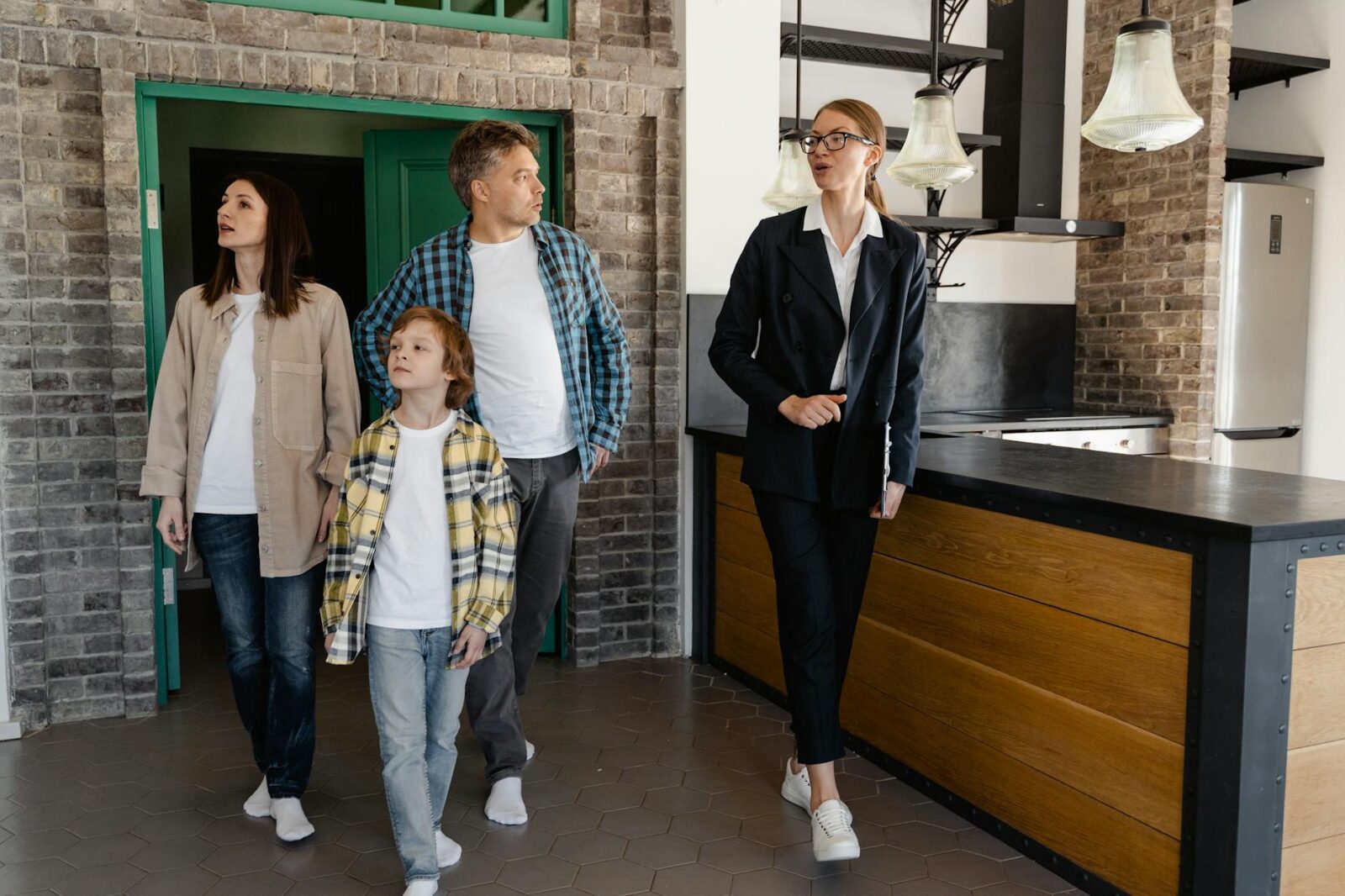 a real estate agent touring the family inside a house Selling a House Fast Doesn’t Have to Be Stressful