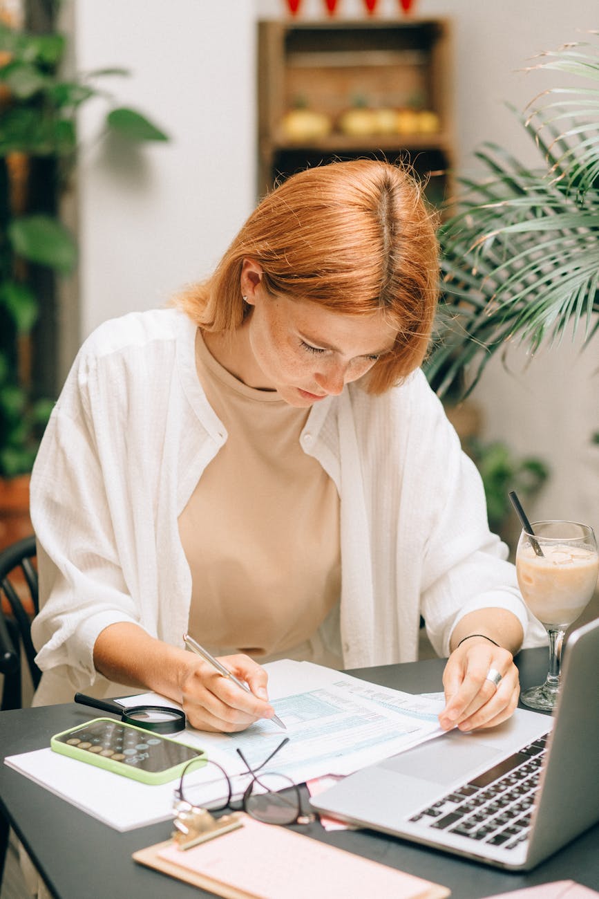 woman coffee smartphone desk Why Streamlining Sales Orders Improves Customer Trust