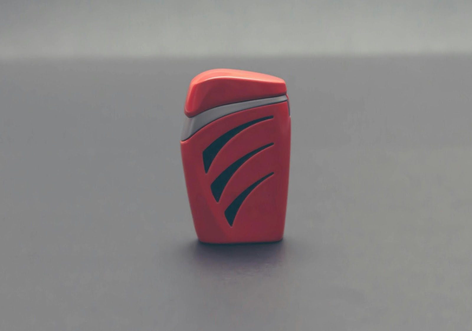 Close-up of a red container with a sleek design, featuring stylized black markings, set against a neutral background. What Goes Into Product Design? 6 Key Steps to Create a Successful Product