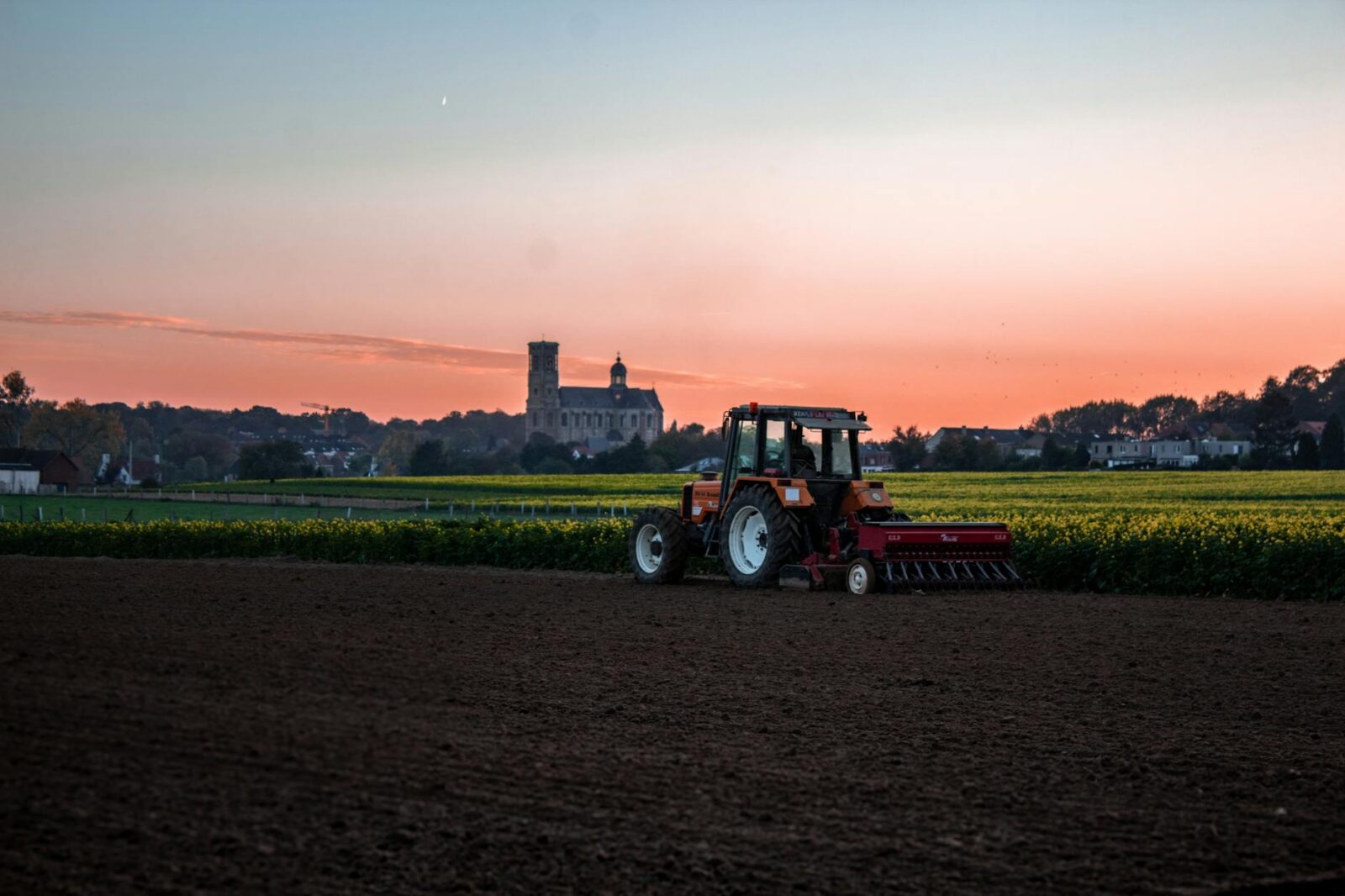 tractor beside grass field 9 Tips to Plan Ahead for the Next Farming Season