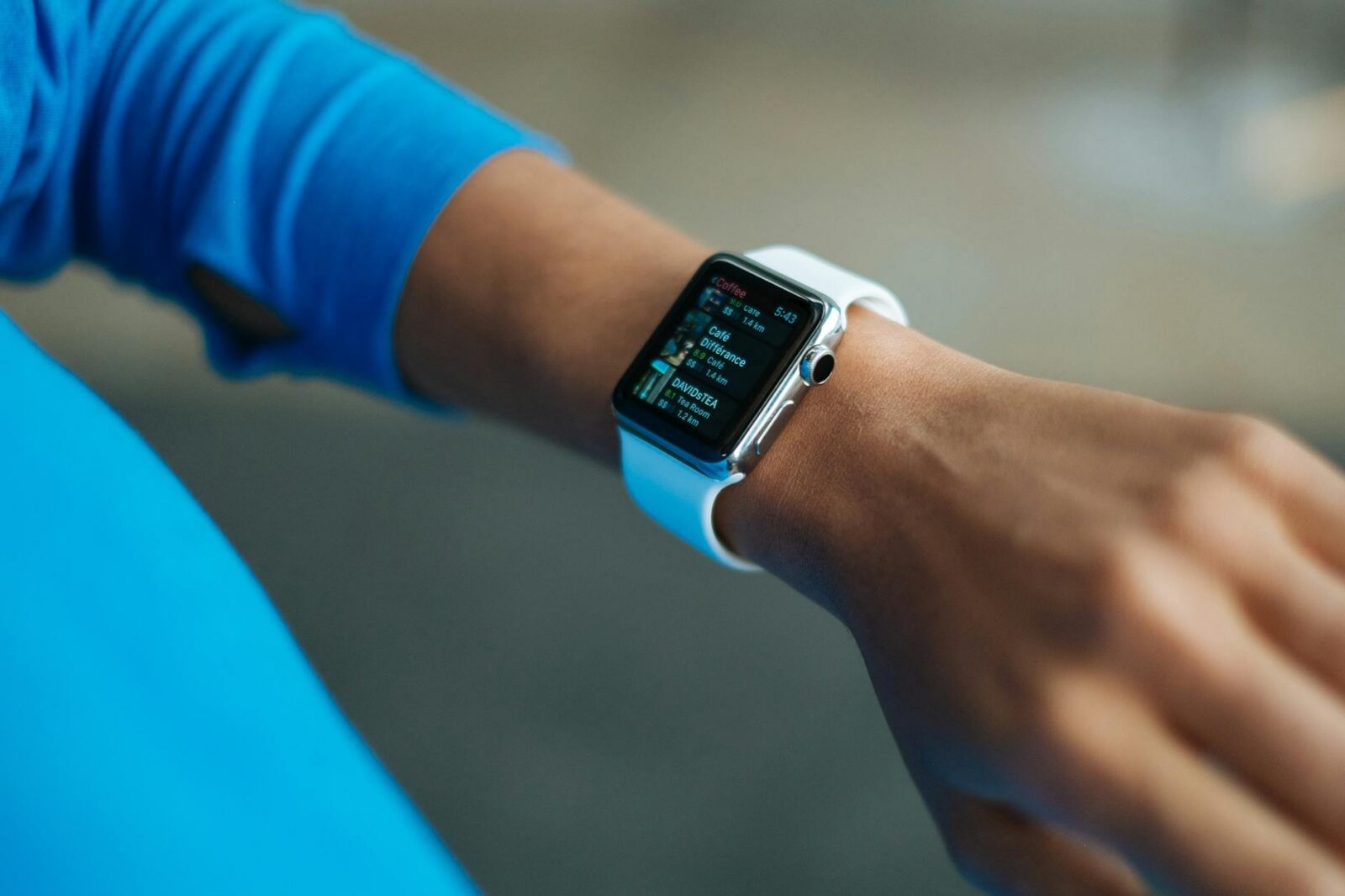 person wearing white silicone strap black smartwatch The Rise of Practical Smart Gear for Tactical Tech at Home