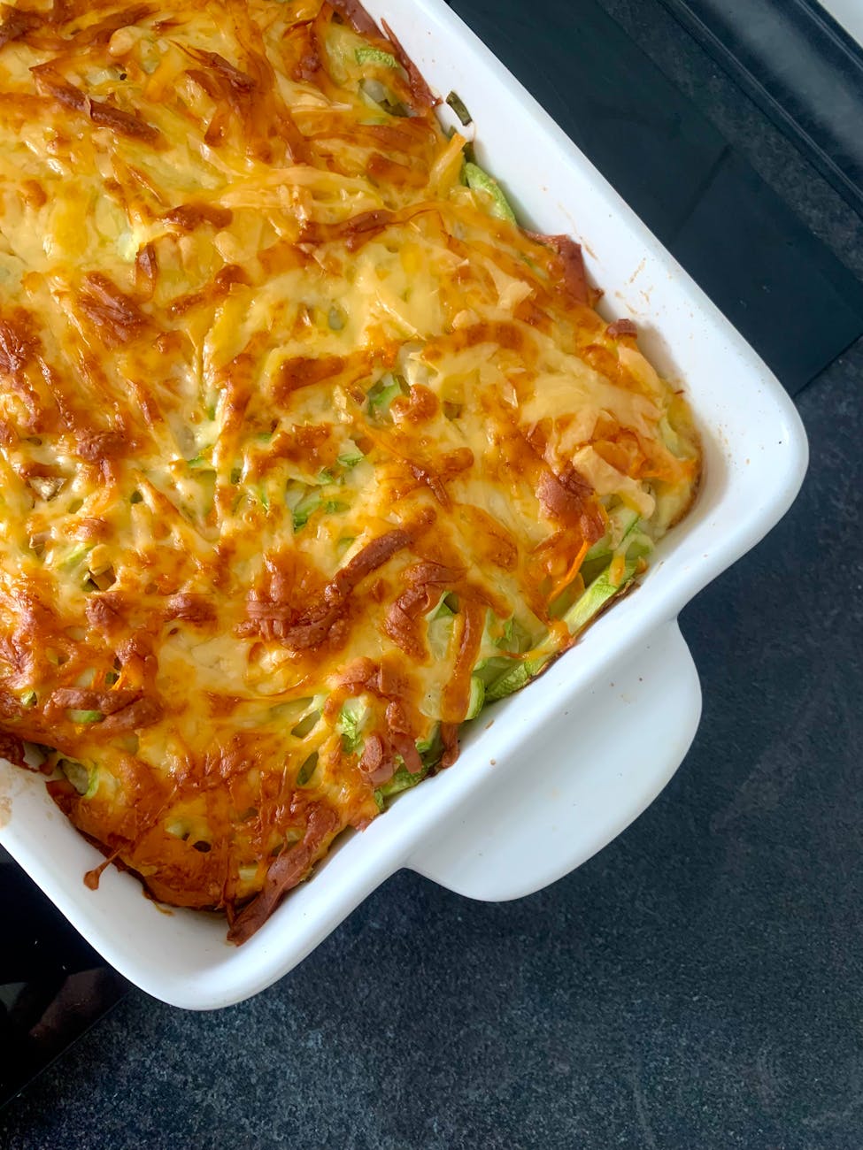 cheesy baked casserole in white dish 20 Cozy Fall Meals Even the Pickiest Kids Will Devour Cheesy Chicken & Broccoli Bake