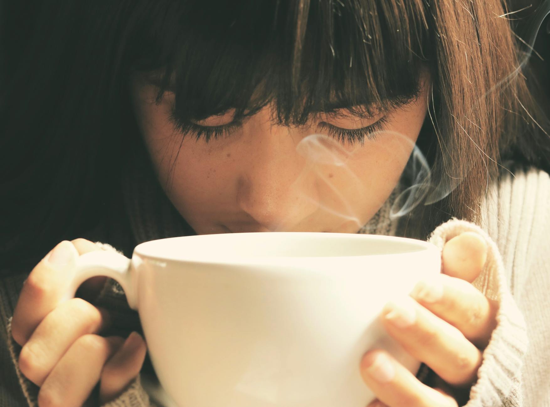 woman holding white cup Calming Techniques for When Your Thoughts Feel Out of Control