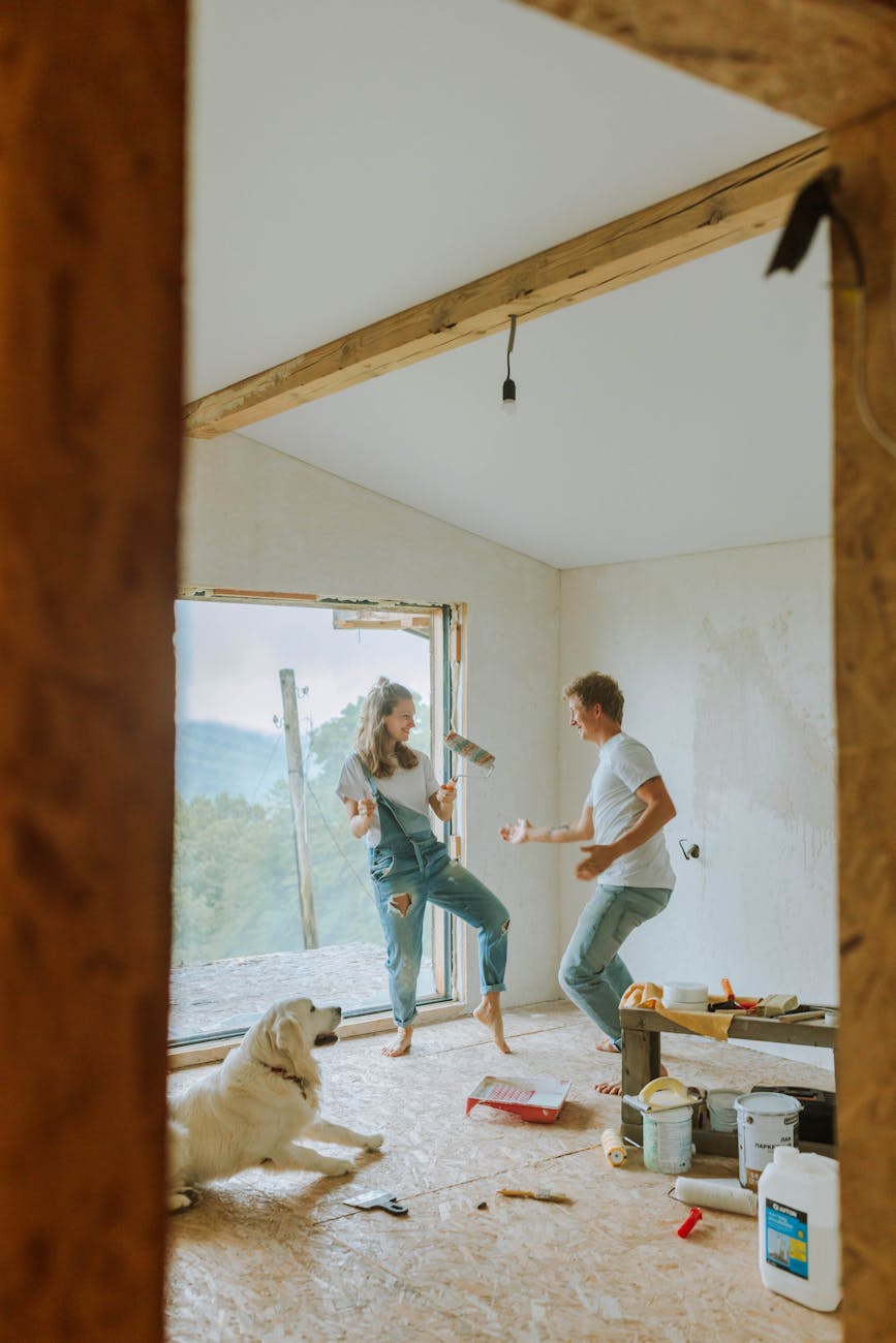 a couple painting a room 8 Things You’ll Regret Not Doing Before Moving Into Your New Home
