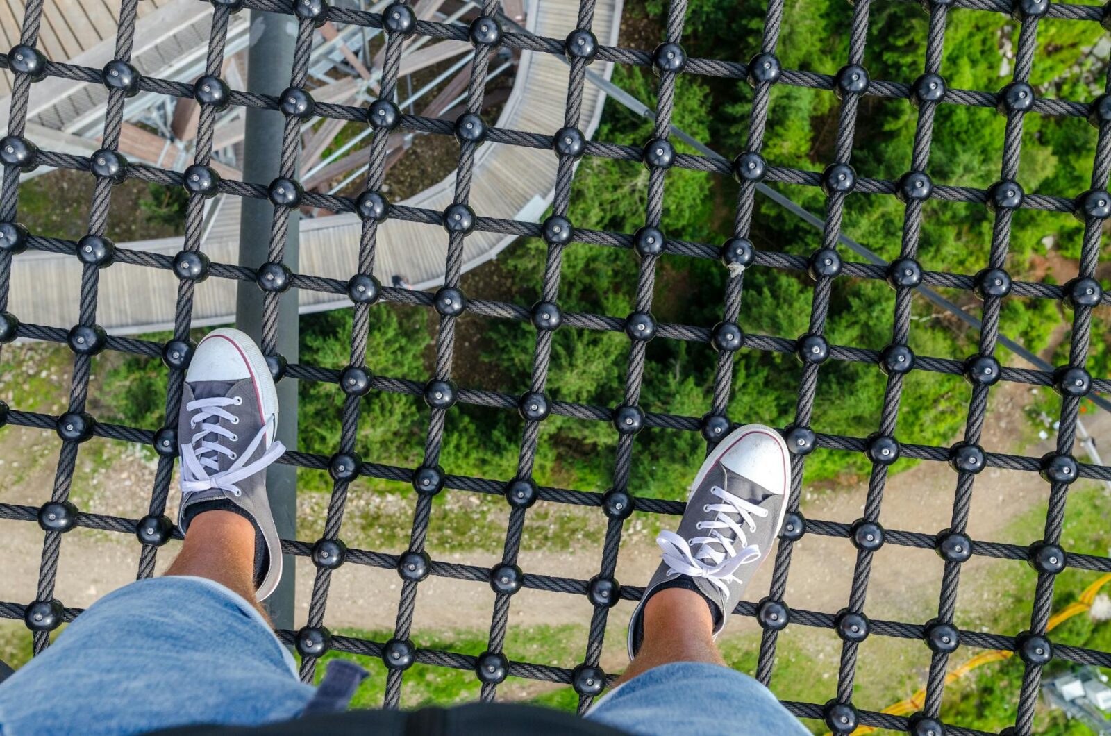 person standing on black steel net Financial Safety Nets When Life Throws Curveballs
