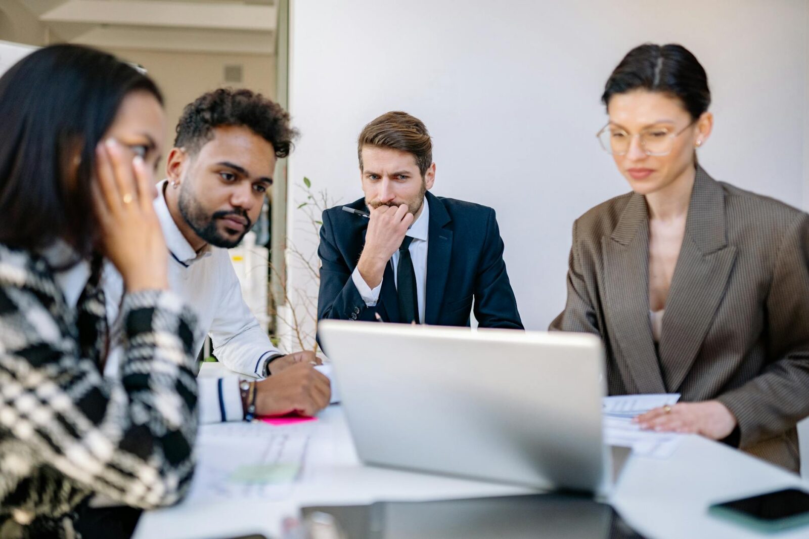 a team sitting watching on the laptop Tech Troubles Slowing Your Business Down? Here’s 8 Ways to Fix Them