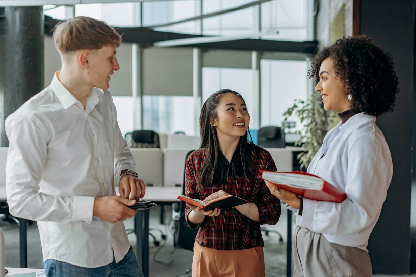 cheerful coworkers talking 10 Ways to Make Clients Feel Comfortable in Your Office