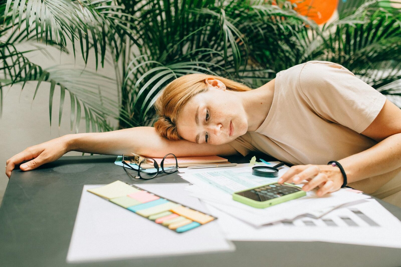 a woman using a calculator using smartphone A Simple Guide to the 2026 IRS Tax Tables