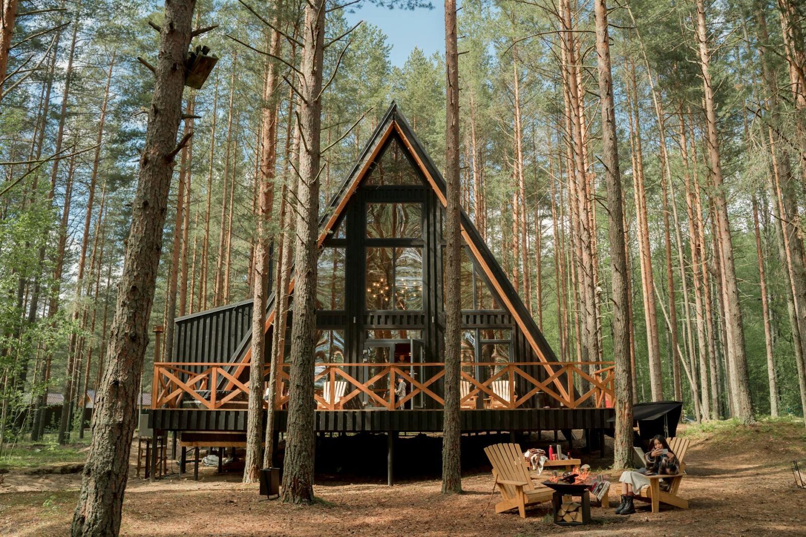 a wooden house with glass wall on camping site What Would You Do With $100,000? Tips From a Pro Investor Owning Vacation Rentals