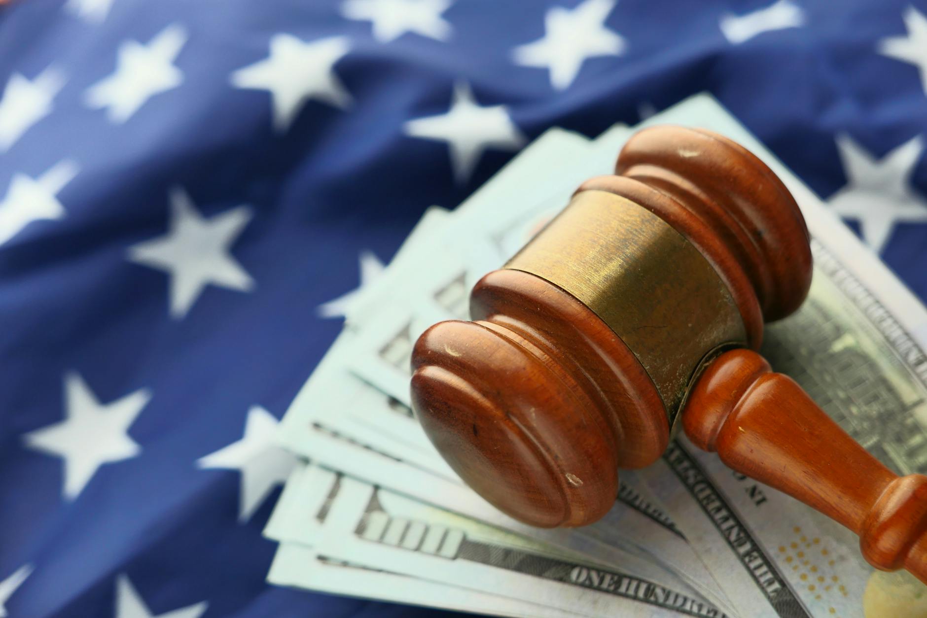 close up photo of wooden judge gavel over paper bills 7 Innovative Ways to Start Climbing the Property Ladder in 2025