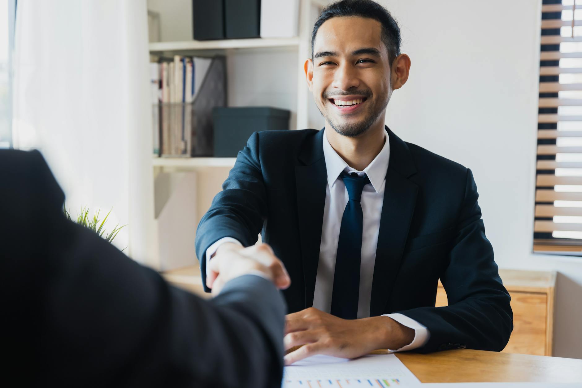 successful negotiate and handshake concept two businessman shake hand with partner to celebration partnership and teamwork business deal 7 Innovative Ways to Start Climbing the Property Ladder in 2025