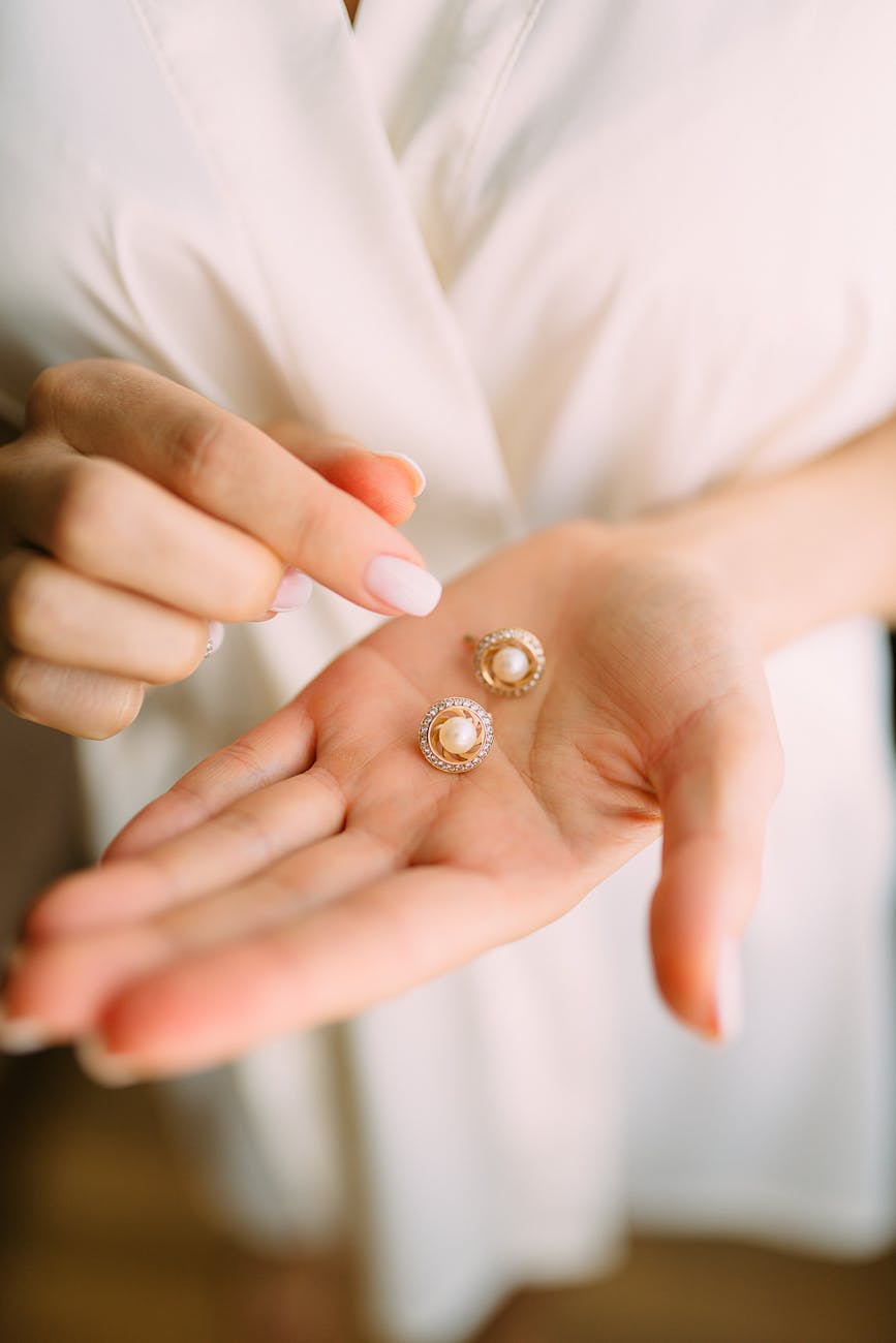 close up photo of person holding earrings Best Diamond Gold Stud Earrings for Women