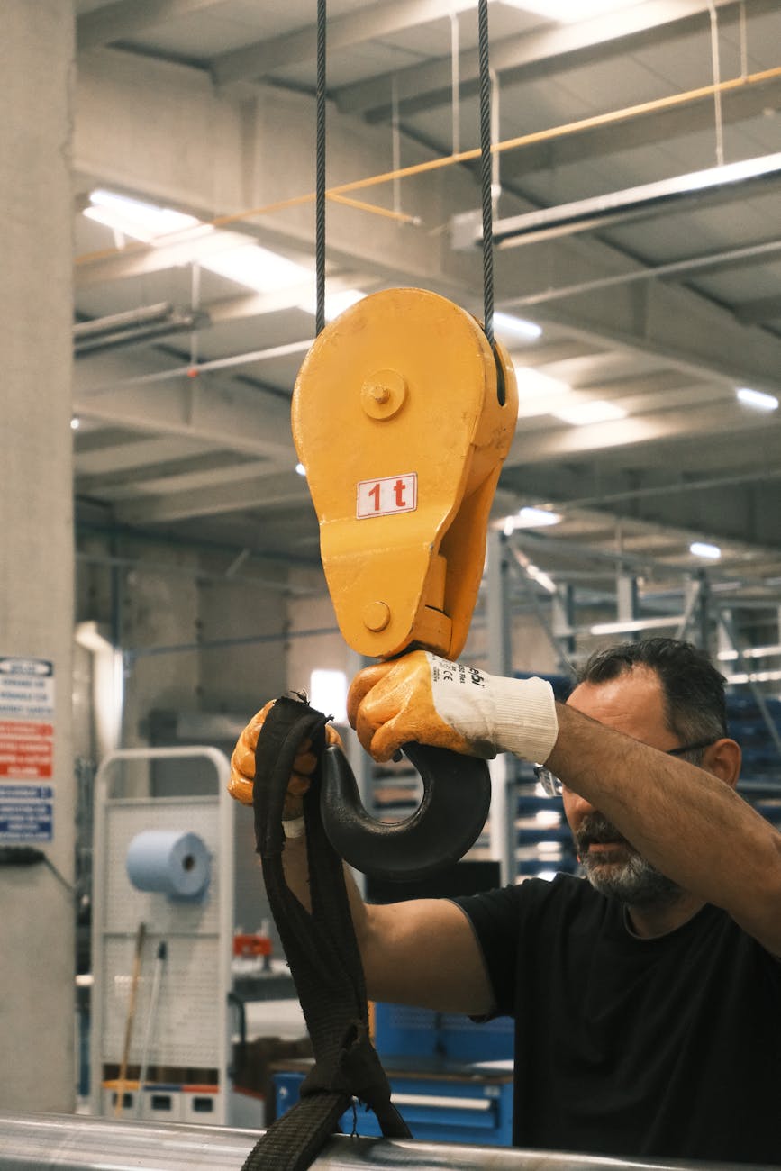 industrial crane hook in use at factory How Automation Is Transforming Heavy Metal Fabrication