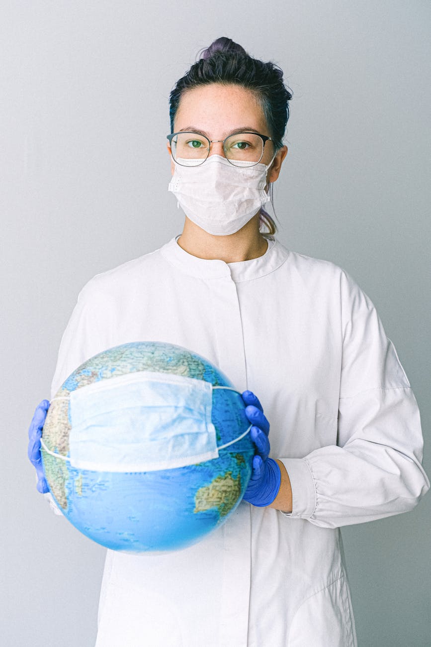photo of person wearing protective wear while holding globe 6 Careers That Let You Travel and Work At The Same Time