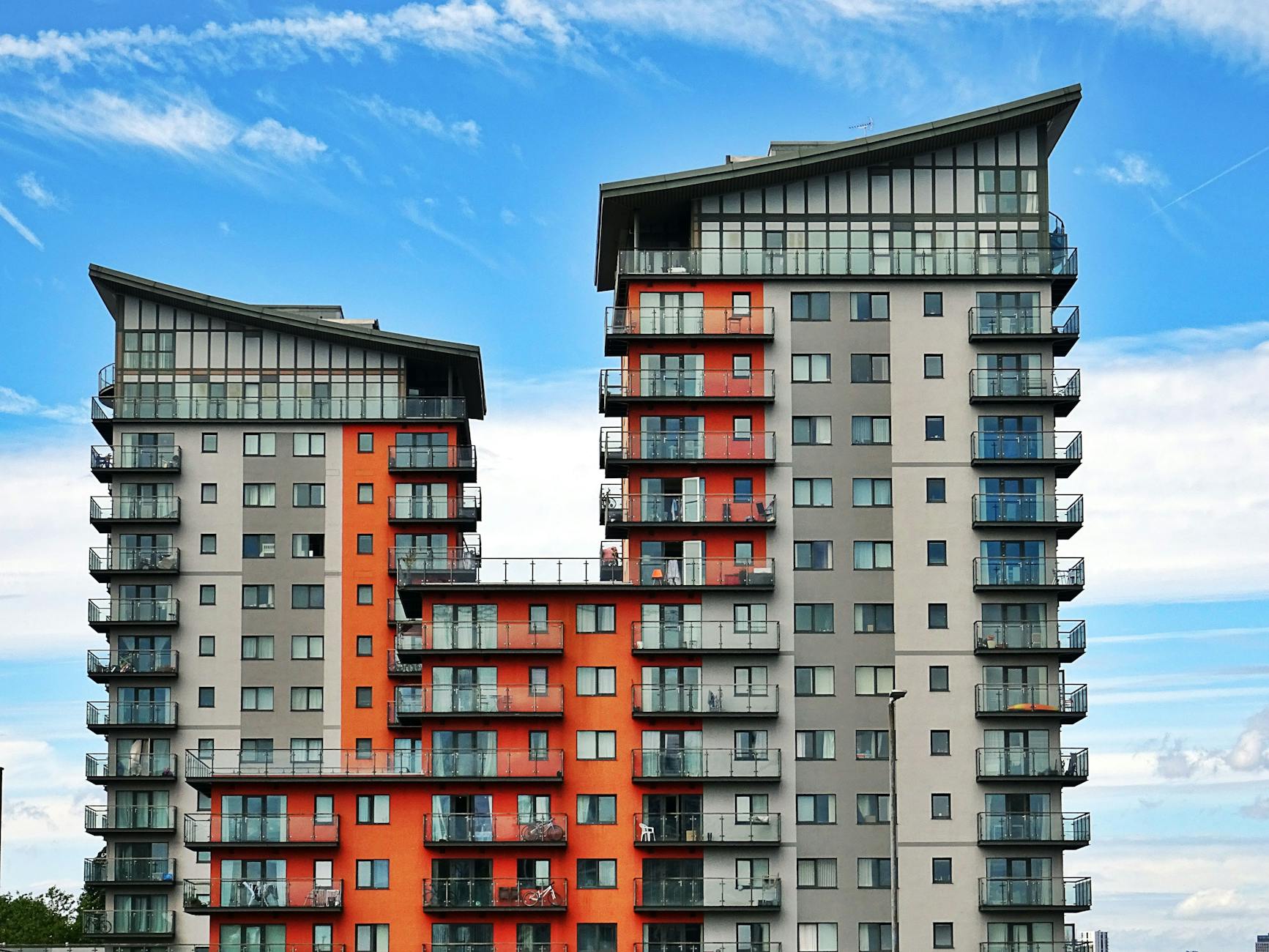 gray red and orange concrete building 7 Innovative Ways to Start Climbing the Property Ladder in 2025