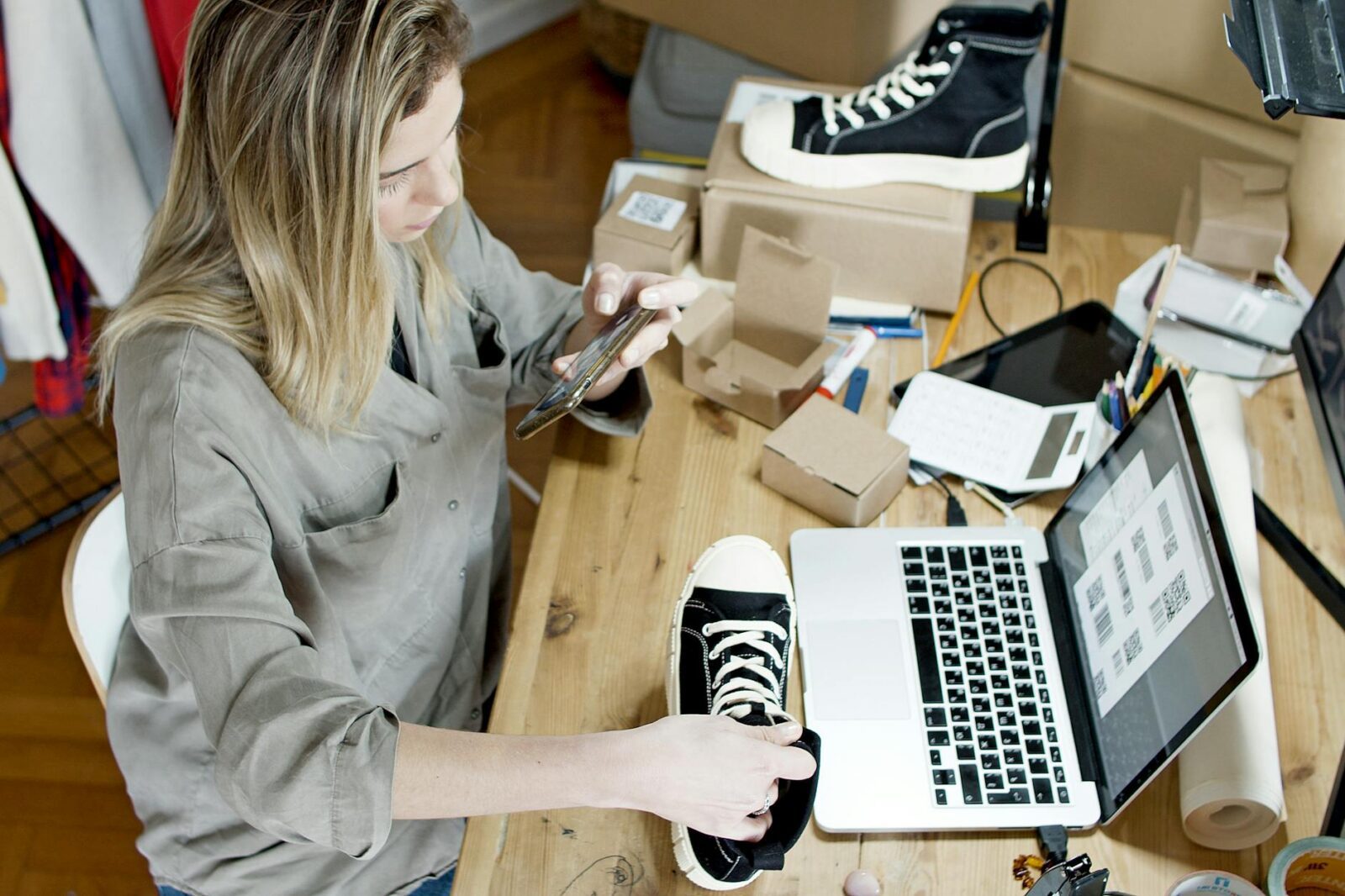 woman taking photo of the product The Sanity-Saving Guide for Online Store Owners