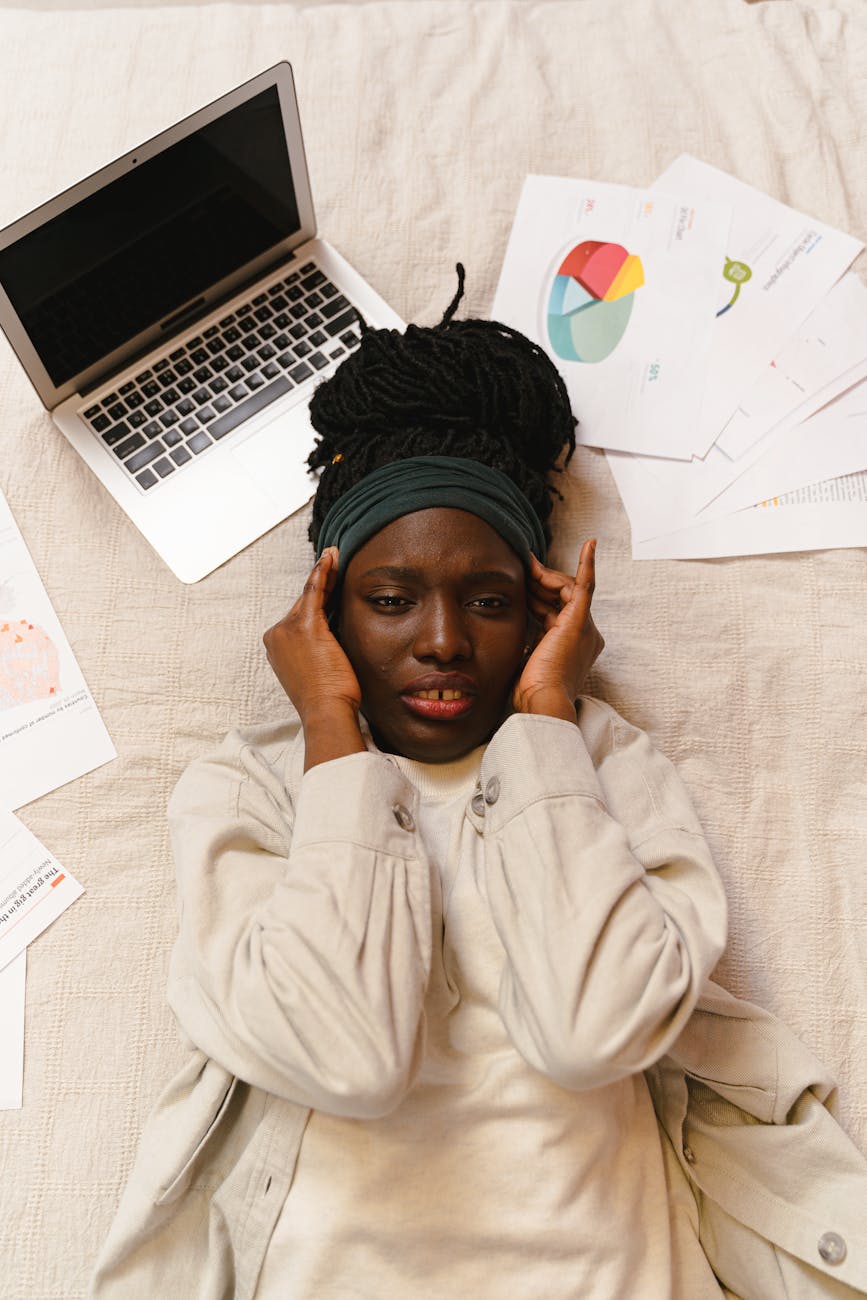woman in pain lying near a laptop How Bad Marketing Can Hurt More Than Just Your Business