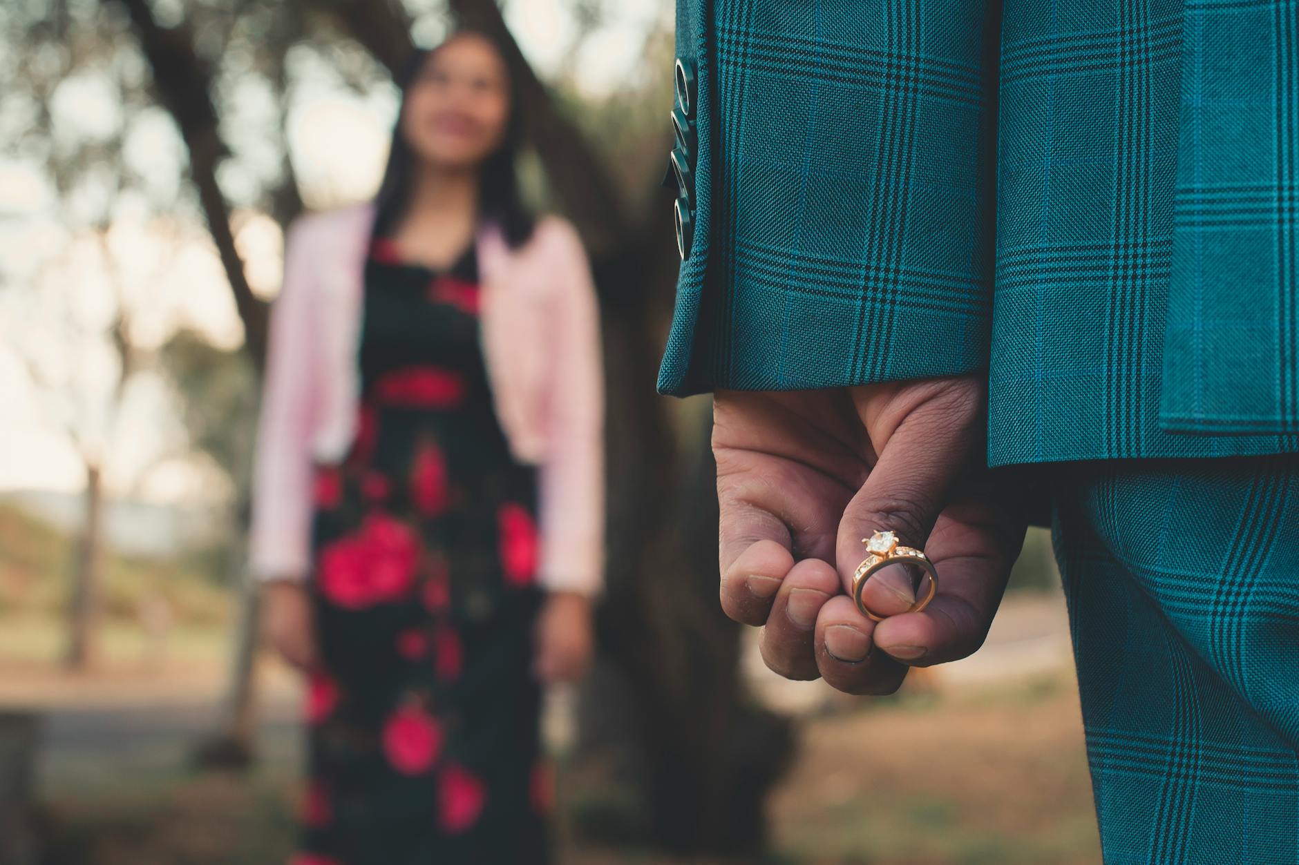 person holding diamond ring Best Stores Where You Can Buy Gold Engagement Rings