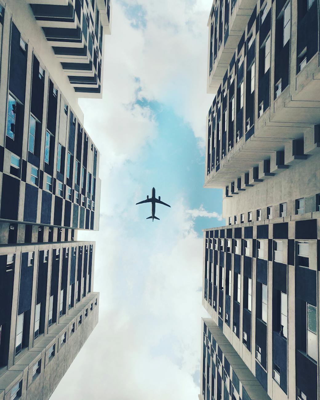 low angle photo of airplane flying Best Airlines to Fly Business Class to the UK from the USA (2026 Guide)